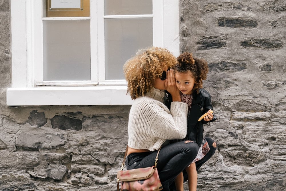 An image of two people telling a secret. Even when using the API to gather information about a customer, that information is kept private between the agent and the customer.