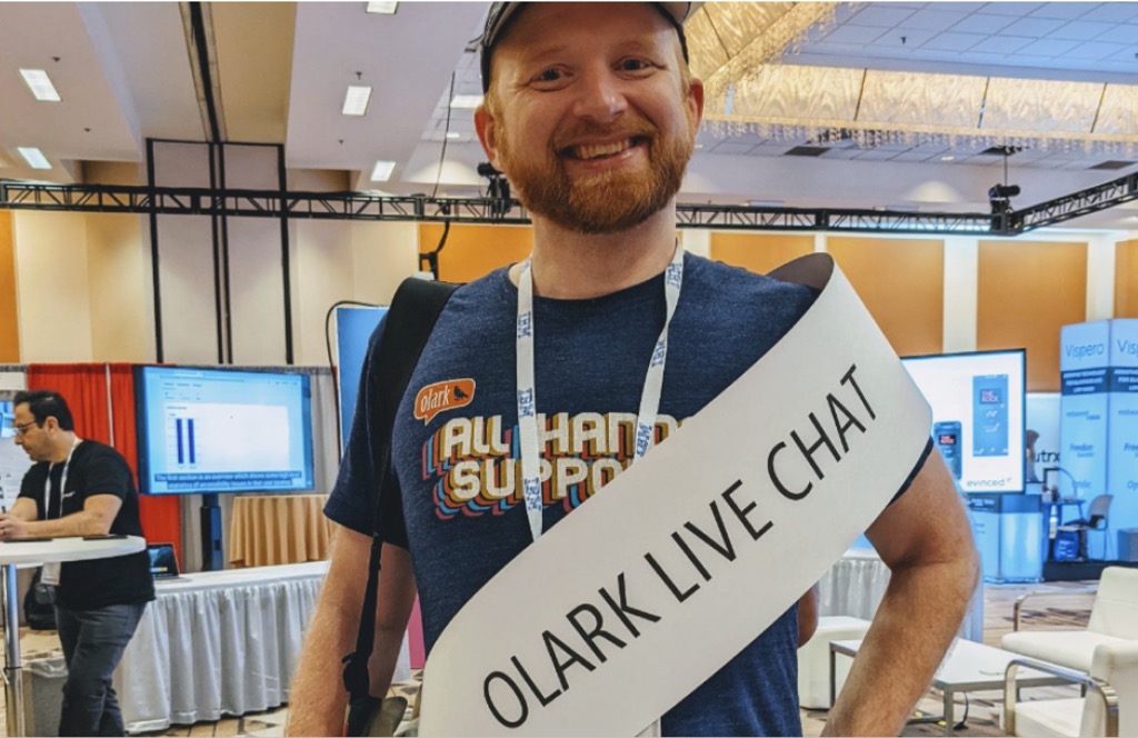 A rediculous photo of Ben Congleton, CEO of Olark at CSUN wearing our booth sign as a sash similar to what happen in a beauty pagent