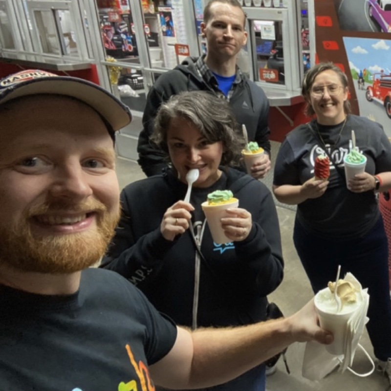 A bunch of Olark employees getting italian ice together, including Kelly, Olark's head of marketing who has a big smile and is double fisting two cones.